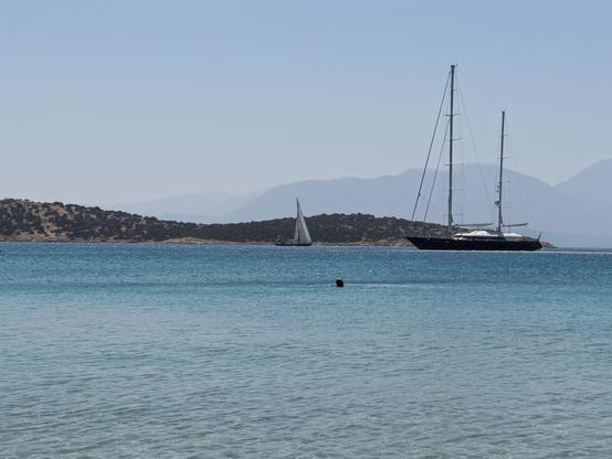 Sailboats on clear blue waters near Minos Beach Art Hotel, Crete.