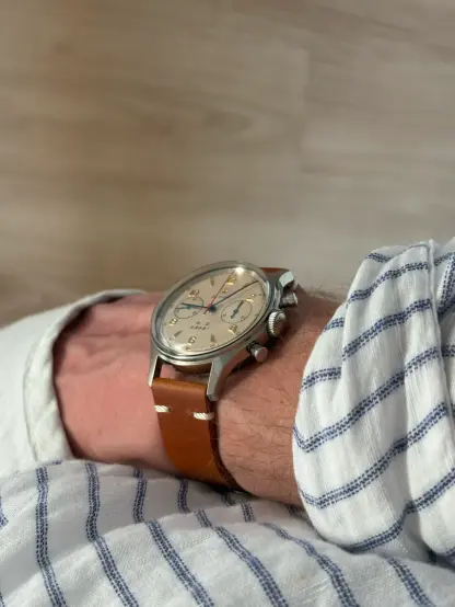The watch on wrists while the hand is in a linnen pants
