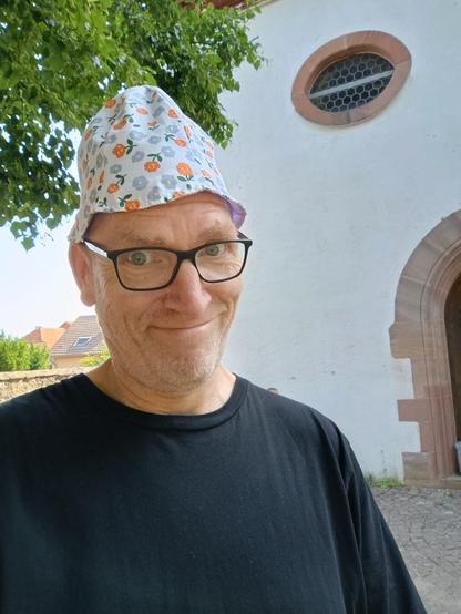 me with a baby hat in front of a church