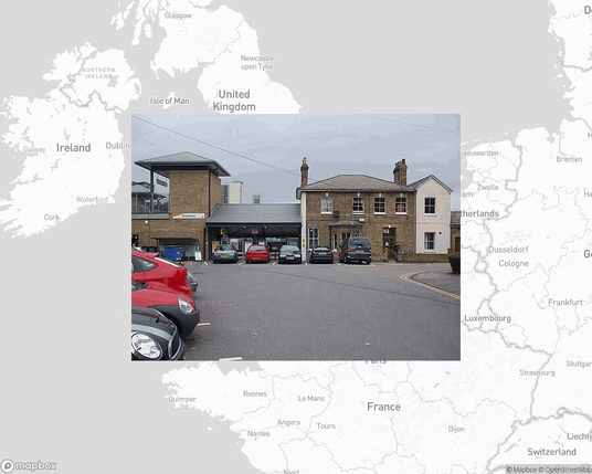 A photo of or from a train station from the linked website, overlaid on a cropped world map where it's located.