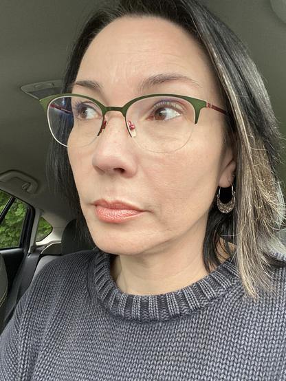 Selfie of a person, sitting in their car, looking into the distance (across the lake, but you can't tell)
