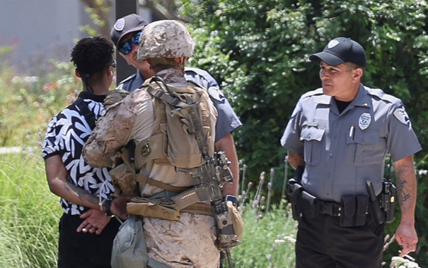U.S. Marines detain a person outside the Wilshire Federal Building after Marines were deployed to Los Angeles, as protests against federal immigration sweeps continue, in Los Angeles, California, U.S. June 13, 2025. REUTERS/Aude Guerrucci
