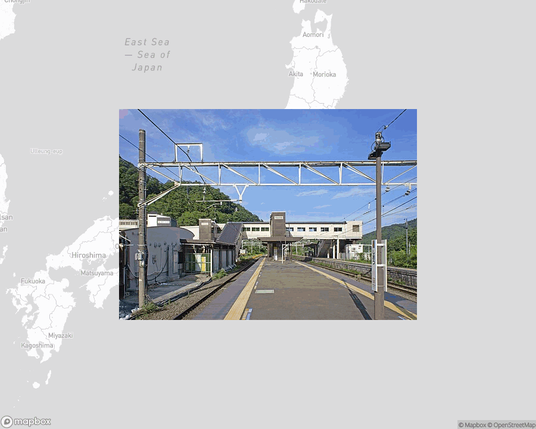 A photo of or from a train station from the linked website, overlaid on a cropped world map where it's located.