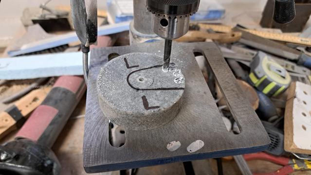 Lead and epoxy are easy to machine. I don't have a mill, but I cut the end off a drill bit and reground it to make a crude end mill. Hand force was all I needed to do the machining of the recessed area.

Bonus: the recessed area also serves as a constraint against the disk spinning around over time.