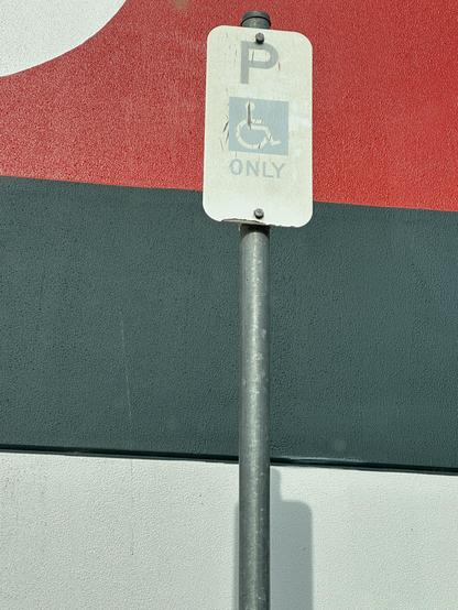 A very faded disabled parking sign at Bunnings Sunbury this morning.