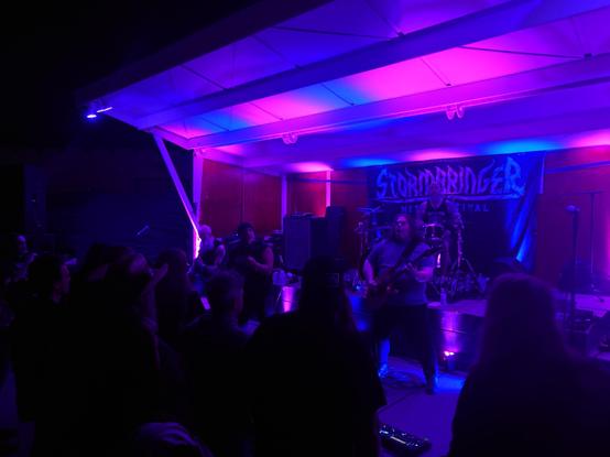 Blood Feast on stage at Ralph's Diner, with some of the crowd pictured in front of them.