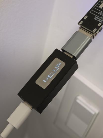 USB buck converter showing 8.18V USB output and pulling 1.12A.