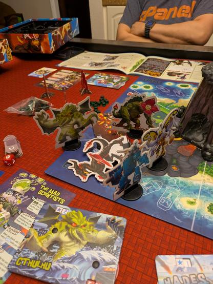 The King of Monster Island boardgame with four cardboard monsters surrounding a fallen boss monster. In the foreground, the Cthulhu monster card is showing.
