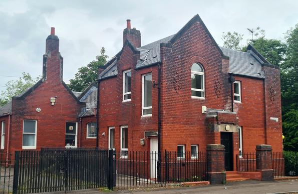 An intricate red brick former school janitor's house in Glasgow.