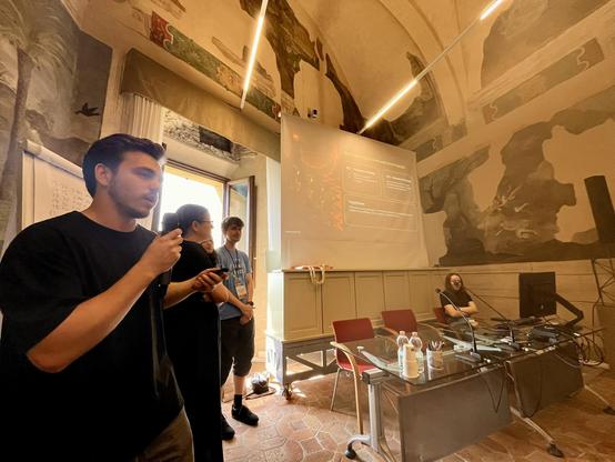 The MOrdor group presenting their work at ISWS2025 in the Fresco Room of Bertinoro Castle