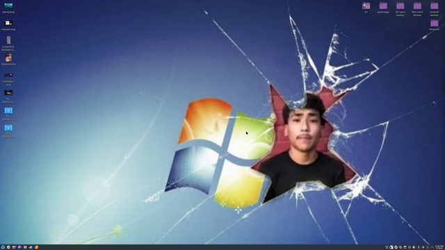 screenshot of my KDE plasma desktop, the wallpaper is an low quality image of the Windows 7 default wallpaper, but near the windows logo has a crack with a gaping hole in it with an image of a guy with a mustache wearing a black t-shirt in front of a red brick wall