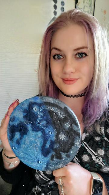 Me holding one of the 8" Daytime Moon Phase paintings.