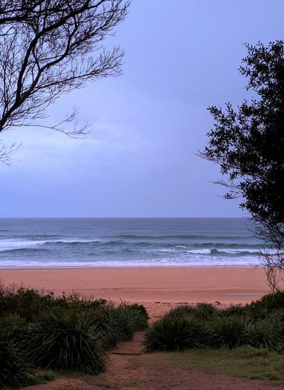 Tasman Sea rolling onto a red ocean beach