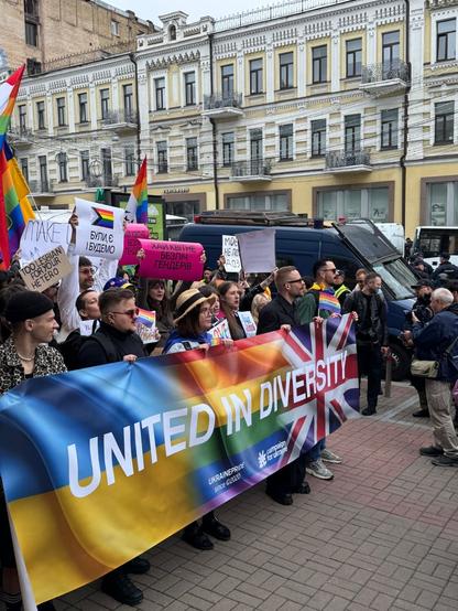 Another close up of the march from the other side. There is a black police riot van behind them.