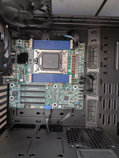 Assrock Altrabud motherboard in a black case.