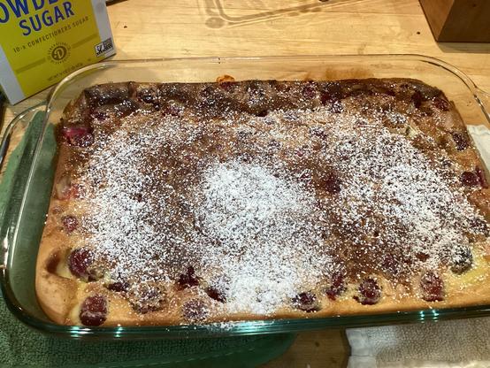 Clear rectangular baking dish containing cherry clafoutis.