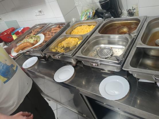 Photo of a kitchen with a bunch of food servings.