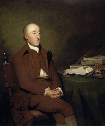 A portrait of James Hutton, painted by Sir Henry Raeburn. Oil on canvas, c. 1776. Hutton – a slim, middle-aged man, clean-shaven and with a receding hairline – sits in a plain wooden chair. His left leg is crossed over his right knee, and his hands are interlaced on his lap. He wears a brown eighteenth-century suit, with knee breeches. To his left is a table covered by a green cloth; on the table are piles of papers and a collection of rocks and fossils.