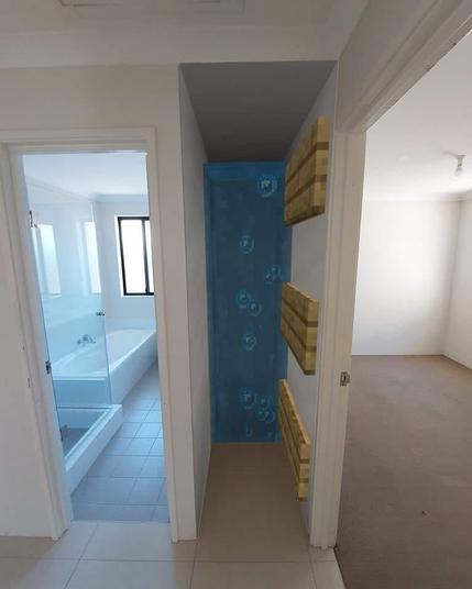 Ein foto einer leeren wohnung in berlin kreuzberg. alles ist schön hell, weis und lofti. links das Bad, rechts wohnzimmer, in der mitte der bubble evlevator nach oben.