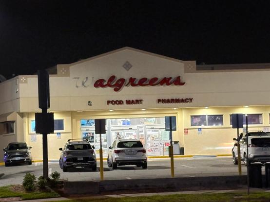 A Walgreens store, shown from outside, its familiar red script sign missing the "W" leaving behind "algreen's."