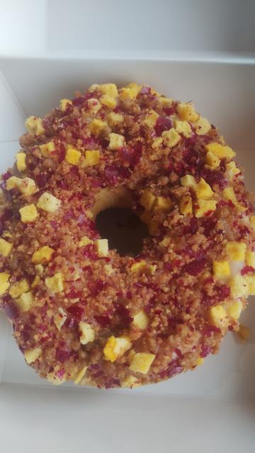 Close up of a peach and raspberry doughnut in Tim Hortons