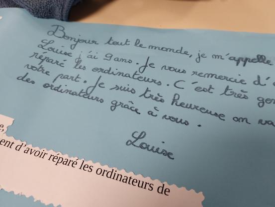 Papier écrit par Louise, élève de CM1 :
"Bonjour tout le monde, je m'appelle Louise j'ai 9 ans. Je vous remercie d'avoir réparé les ordinateurs. C'est très gentil de votre part.
Je suis très heureuse, on va avoir des ordinateurs grâce à vous."
Louise