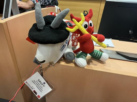 @GroffTheBSDGoat@bsd.cafe Beastie play date. Groff and a handmade Beastie plush hanging out on the bsdcan DMS1160 podium.