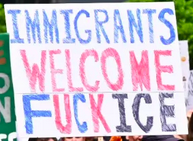 protest sign reads: immigrants welcome / fuck ice