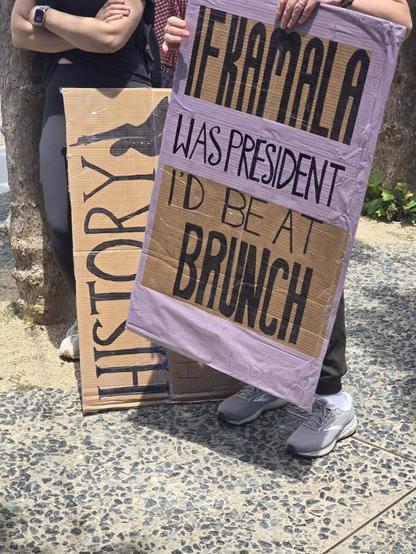 Protest sign that reads "If Kamala was president, I'd be at brunch"