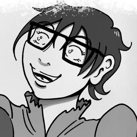 A woman with eyeglasses is giving a joyful smile.