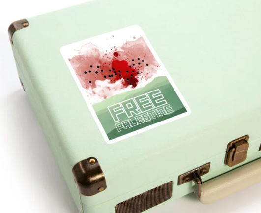 a large sticker shows a watermelon landscape with a bloody sky