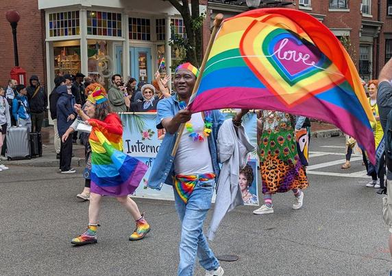 Man waving Pride/Love flag