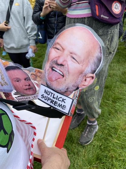 Image of politician on a stick, tongue out, labeled NUTLICK SUPREME