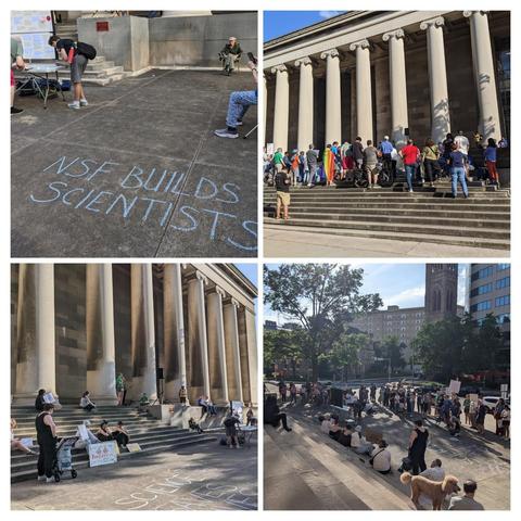 The image is a collage of four photographs depicting a protest or demonstration in front of a large building with classical architecture, characterized by tall columns. The top left photo shows a person writing on the ground with blue chalk, spelling out "NSF BUILDS SCIENTISTS." In the top right photo, a group of people is gathered on the steps of the building, some holding signs, with a rainbow flag visible among them. The bottom left photo shows more people sitting on the steps, some holding signs, with the same chalk message on the ground. The bottom right photo captures a larger group of people in the street, with some sitting and others standing, holding signs, and a dog is visible among the crowd. The overall atmosphere suggests a peaceful demonstration with a focus on science and inclusivity.