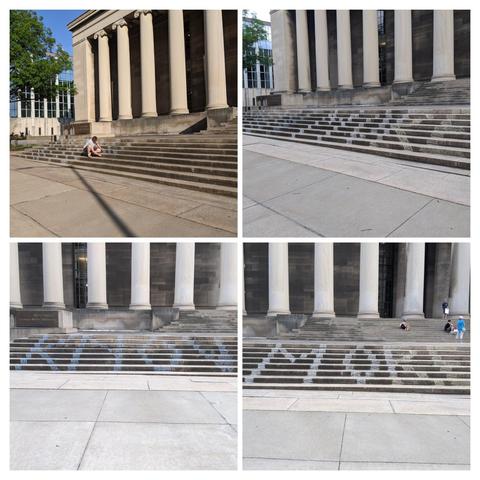The image is a collage of four photographs depicting a grand building with large columns and wide stone steps. The building has a classical architectural style, with tall, white columns supporting a dark facade. The steps are made of stone and are wide, leading up to the entrance of the building.

In the top left photo, a person is sitting on the steps, wearing a white shirt and shorts, with a tree and a modern building visible in the background. The top right photo shows the same steps without the person, with the architectural details of the columns and the steps that have chalk on the vertical portion

The bottom left photo features the steps with the word "KNOW" chalked in blue on the steps, while the bottom right photo shows the steps with the word "MORE"  in white.