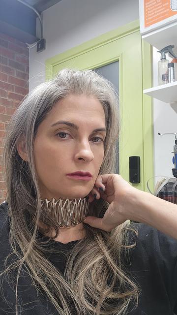 Katherine checks the fit of Xover0's solid sterling silver choker necklace.