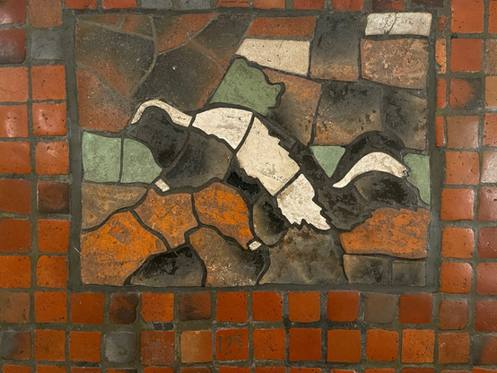 photo of of one of two skunk mosaic tiles on the PA Capitol rotunda floor from 1906, numbered 125 - the less worn of the two