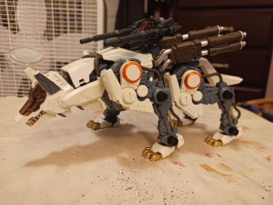 A photograph of the original command wolf I built in 2023. It now resembles the motorized kit from the original Japanese release of Zoids back in '84, save for the weapon lacking a gunner's seat and the orange rings around the shoulder armour. And the greater degree of detail and colour separation, of course.