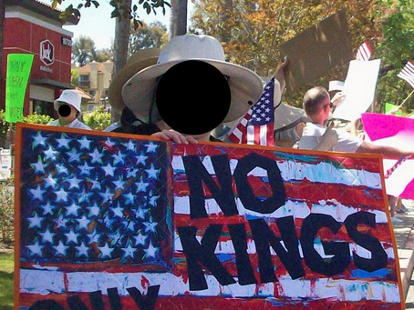 American boomer holding sign "No Kings." Their Face is obscured as policy by No Kings participants because they rightly fear their " government" disappearing or attacking them for protecting, defending restoring the American Denocracy.