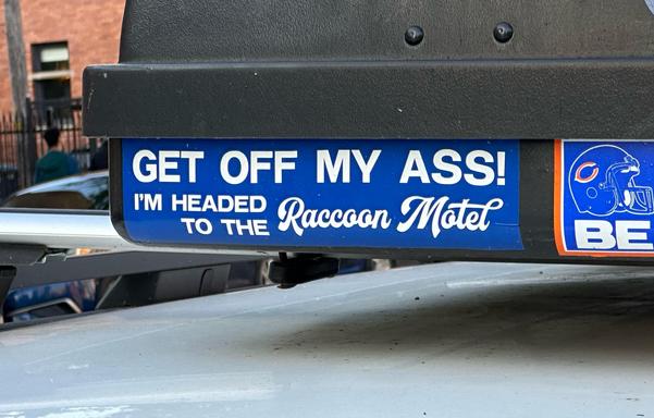 A sticker that says “get off my ass! I’m headed to the raccoon motel”