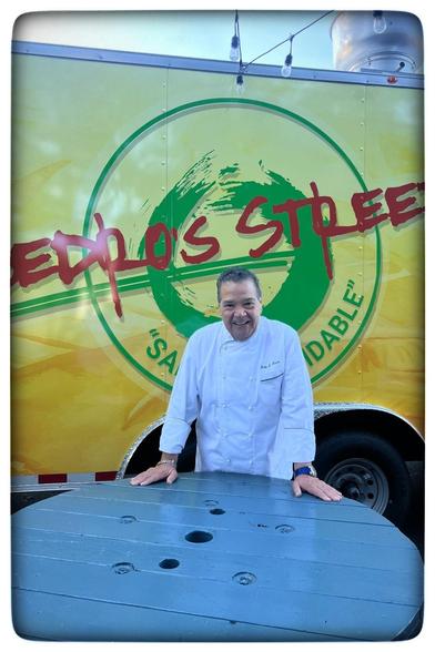 Pedro standing in front of his Food Truck