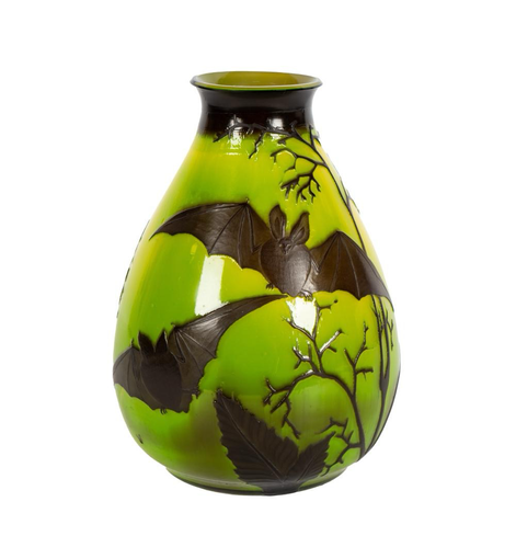 official auction photo #1, front profile on white background: cameo glass vase, lime green base color with dark brown decoration of flying bats among branches and leaves