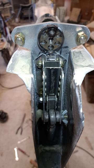 The top of the vertical fin, aft end, looking forward. The aluminum 'dog bone' is bolted to the fin spar (carbon fiber), and the elevator auto-connect fork (and its bracket) are also bolted to the dog bone.