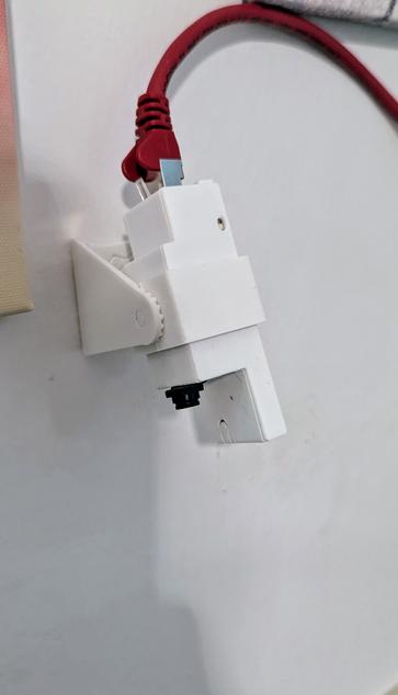 photo of wall-mount actually being mounted on the wall and holding the enclosure with the ESP32 inside.