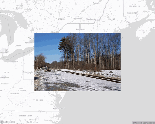 A photo of or from a train station from the linked website, overlaid on a cropped world map where it's located.