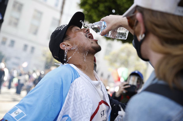 A protester in Los Angeles tries to rinse tear gas after the altercation with police late Saturday afternoon. (Stephen Lam/AP)