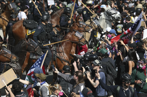 What had been a calm demonstration in downtown LA quickly turned chaotic when police on horseback charged at the crowd, striking some w/ wood rods & batons as they cleared the street.