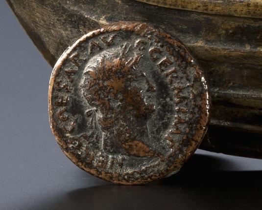 A Roman bronze coin, used as one of the ship's wheels, depicting Emperor Nero.