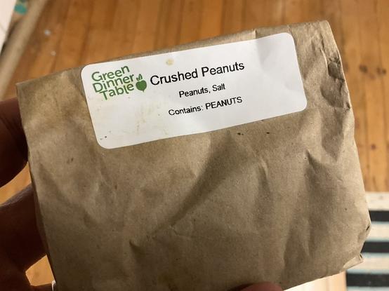 A photo of a paper bag with a label that says 

Crushed Peanuts
Peanuts, Salt
Contains: PEANUTS