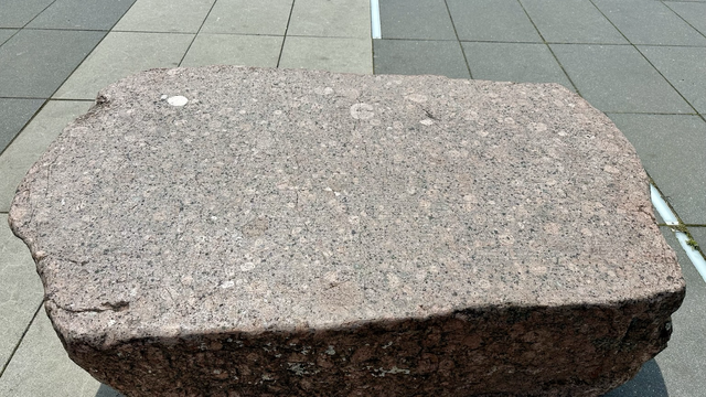 A flat piece of pink granite